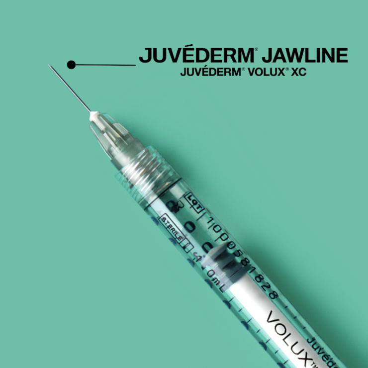 Intravenous syringe with Juvederm branding on a green background