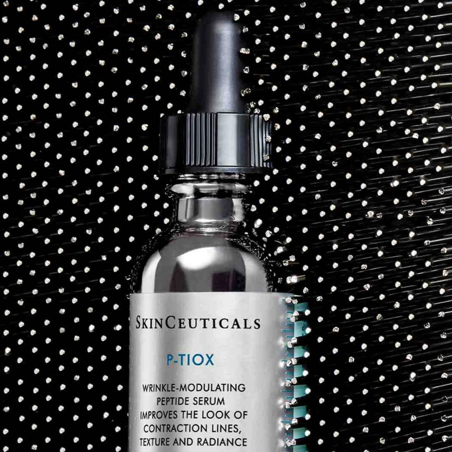 SkinCeuticals P-TiOX serum bottle with black background